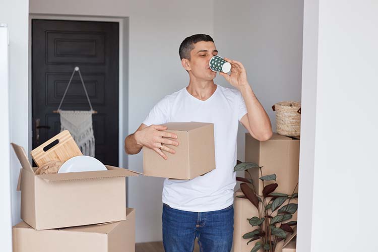 summer moving tips - man staying hydrated during move